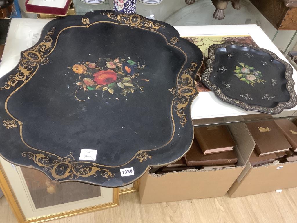 A Victorian papier mache shaped tray with painted floral panel with mother of pearl and a smaller similar tray, largest 78 x 59cm